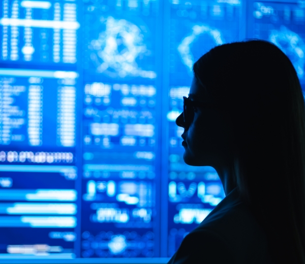 Silhouette of a woman staring at a screen