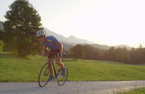 Man on a road bike doing a hill climb