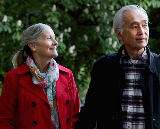 Old couple smiling and walking