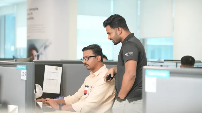 Two Middle Eastern Office Workers Collaborating at a Desk Two Middle Eastern Office Workers Collaborating at a Desk