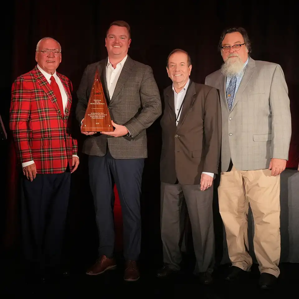 Wood employees picking up the CURT award