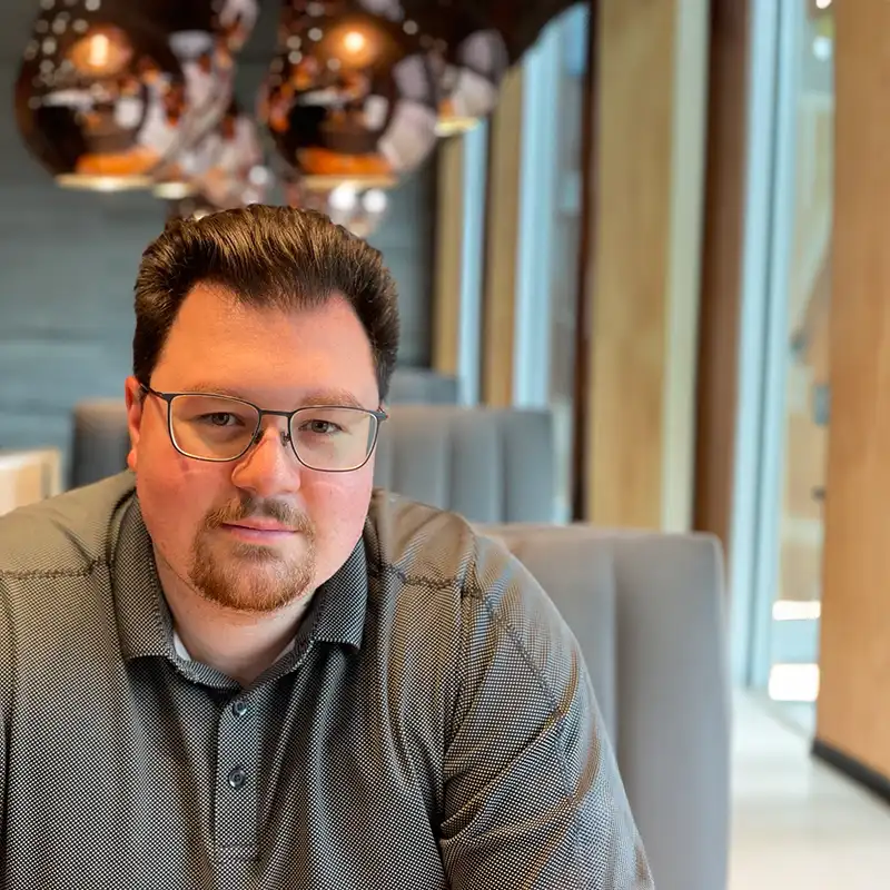 Image of Alex Marthiensen seated in a booth
