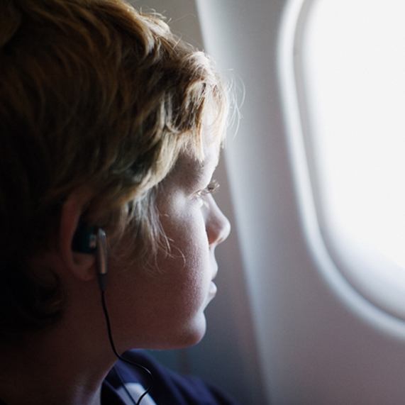 Lad looking out of aeroplane window
