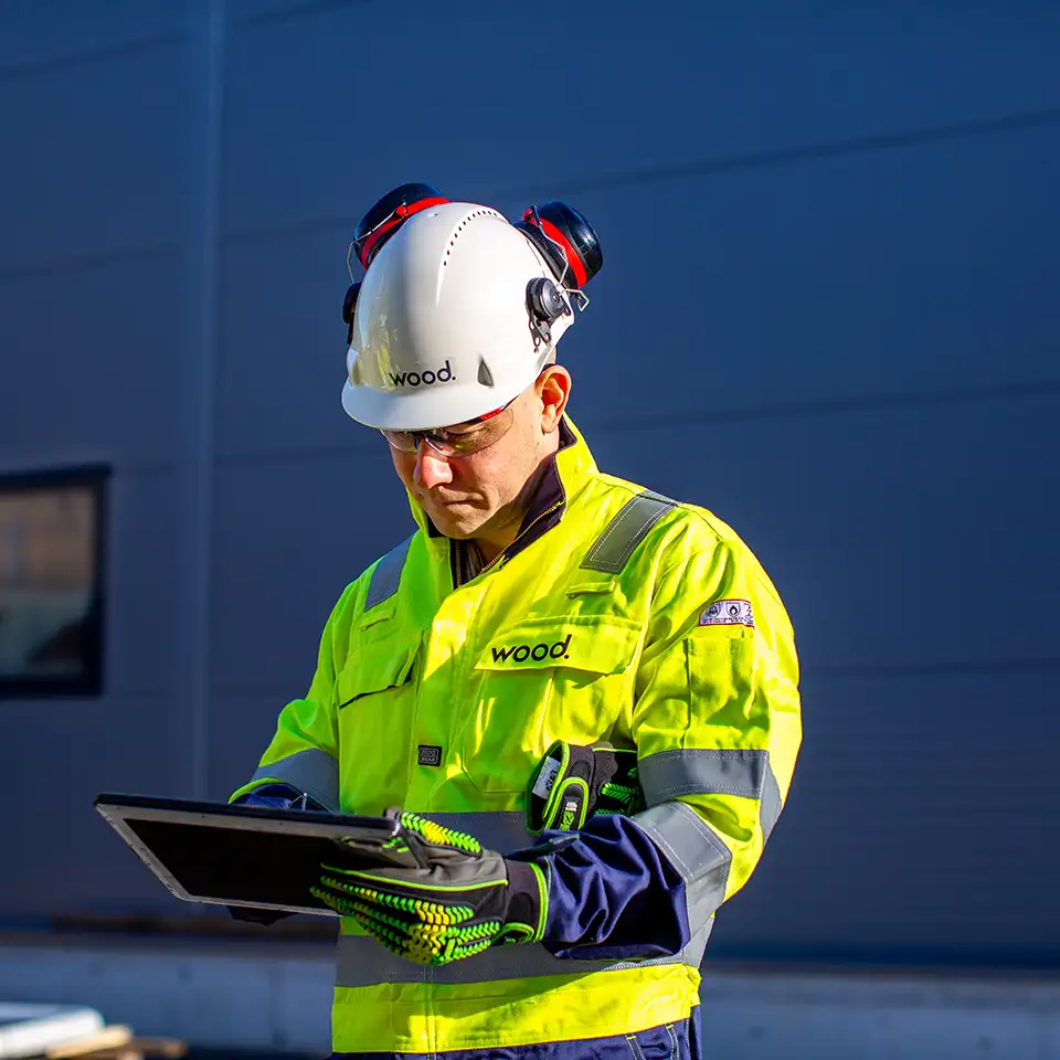 A Wood engineer using a tablet in the yard